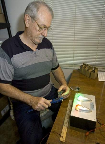 Bob Perigo tests equipment. LED lights for planes are some of the company's best-selling items